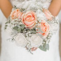 woman holding white and pink rose flower bouquet